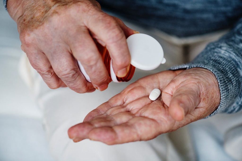 Patient dropping medication on his hand