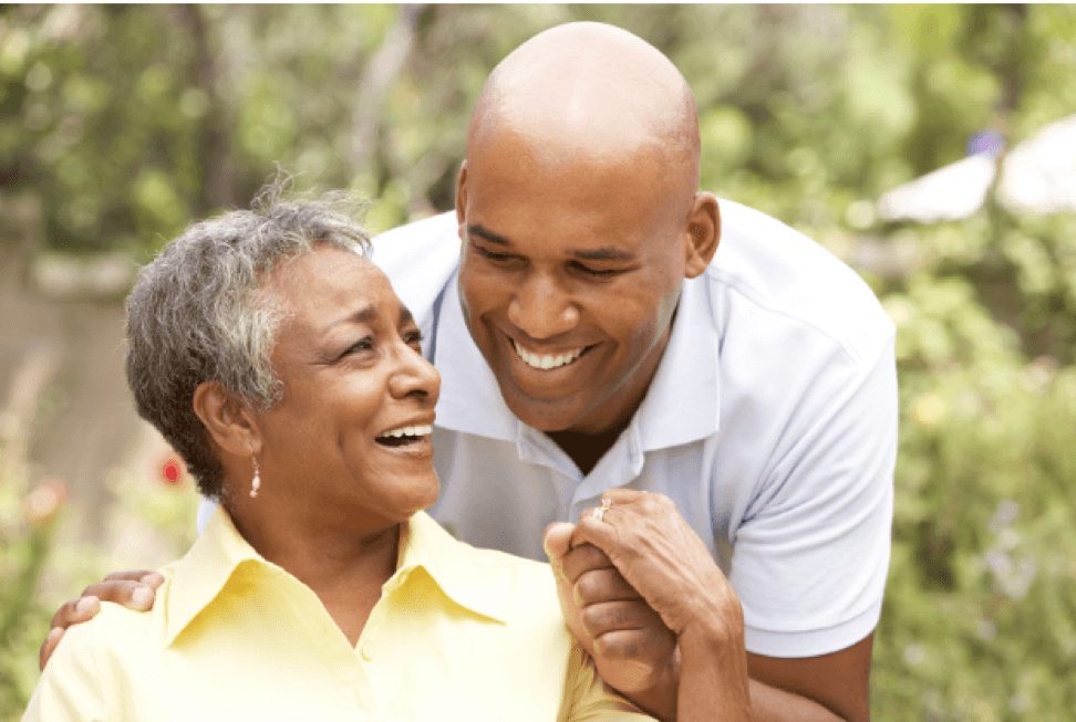 Mother and son holding hands and smiling outdoors