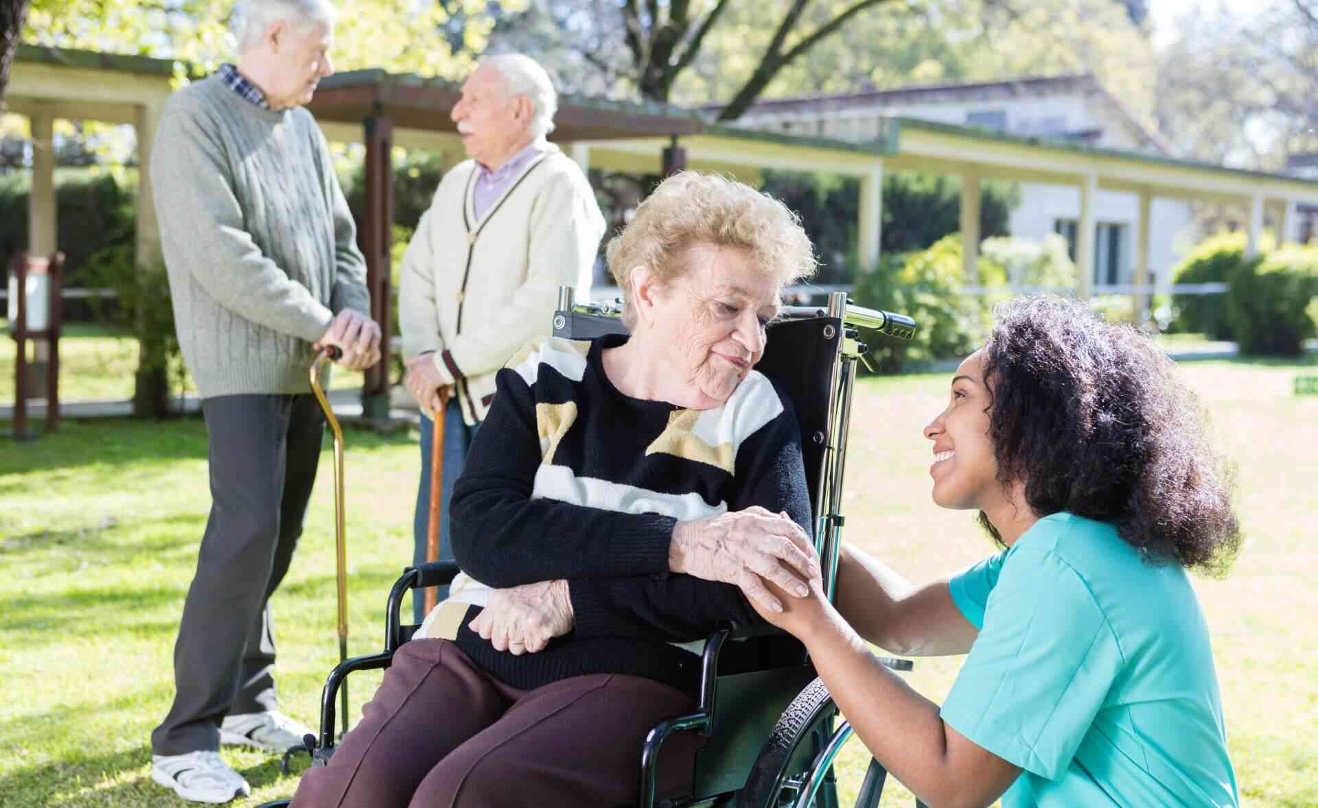 A caring nurse holds an older woman’s hand, encouraging healthy aging in Rockville, MD.