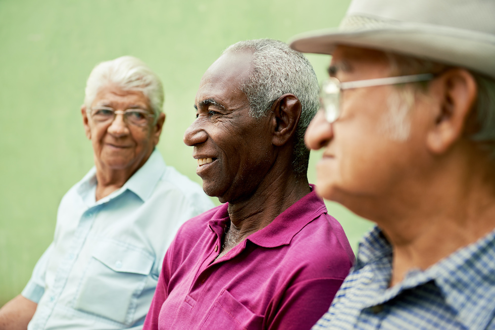 Three elderly men having a conversation about home care