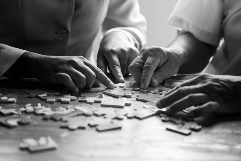 Two people joining the puzzle card in Rockville MD