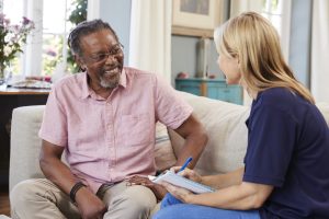 SmithLife Homecare nurse sitting doing an assessment with an elderly man in Washington D.C.