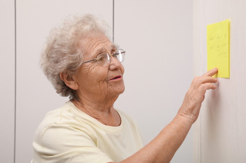 Older adult looking at care list on wall