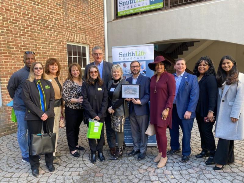 The group of people posing in front of SmithLife Home care in Chevy Chase, MD