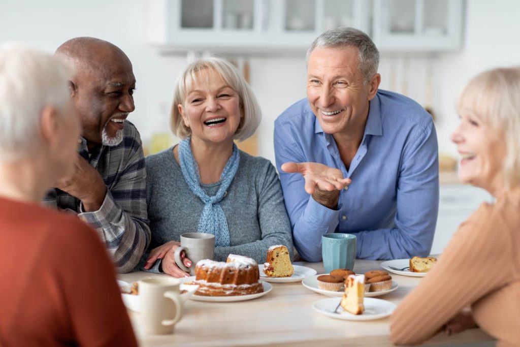 Older adults and seniors talking at a table