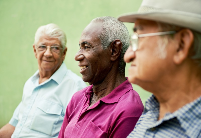 Three older men outside talking in Maryland