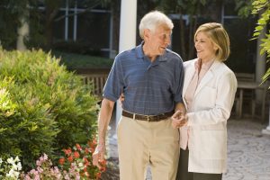 Happy senior couple holding hands, emphasizing the importance of mental health and senior’s well-being.