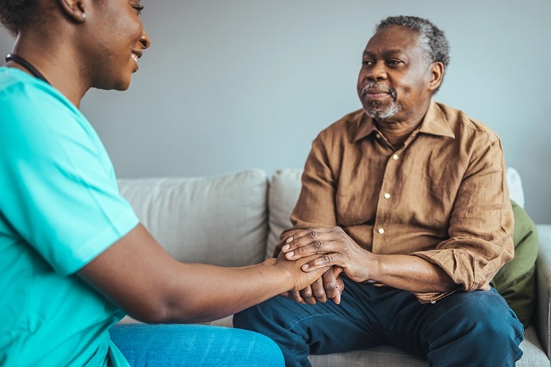 Caregiver providing care & emotional support to a senior during a home visit in Rockville, MD