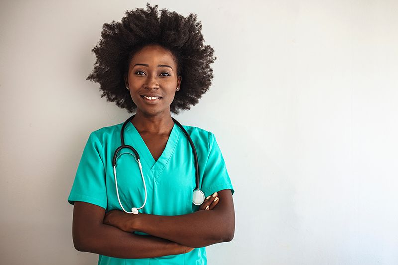 A woman in a green scrub suit, celebrating Happy National Nurses Week in Rockville, MD