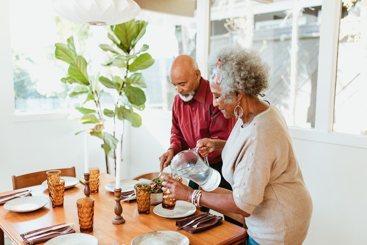 A Senior Couple Preparing a Meal Together at Home, Focusing on a Safe Living Routine
