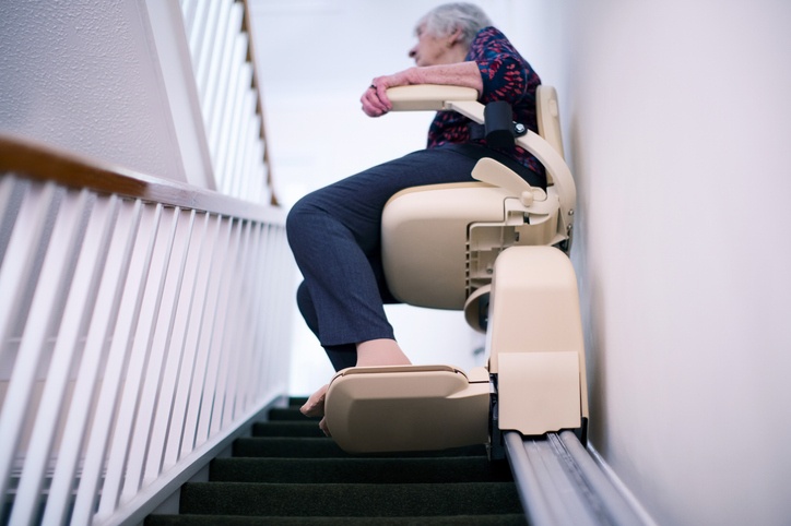 A Senior Using a Stairlift on the Home Staircase for Safe Mobility