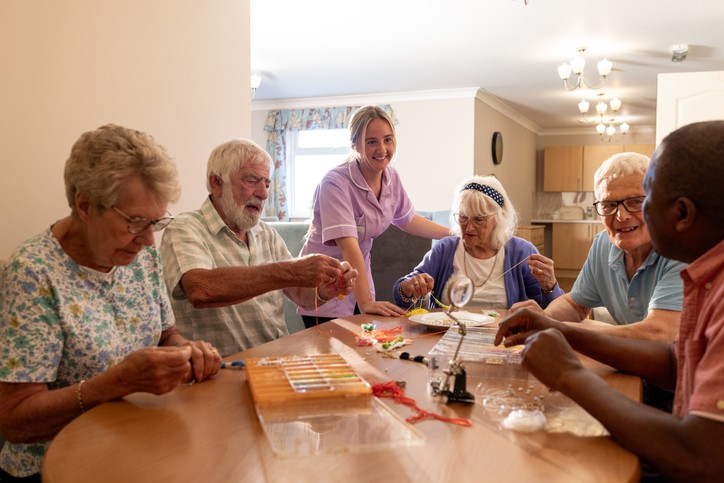 Older adults participating in a group arts and crafts activity with caregiver in Rockville, MD